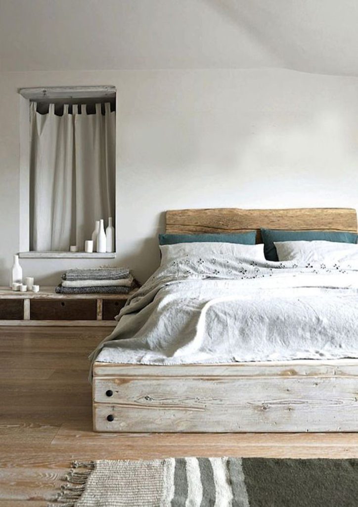 Dormitorio minimal, con cama de madera, decorado en tonos neutros