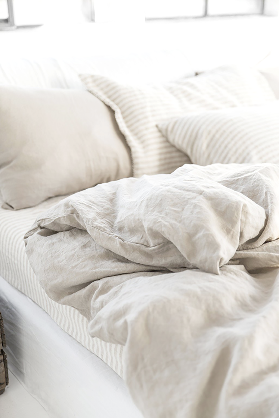 cama con sábanas y plumón blanco de harmony and design