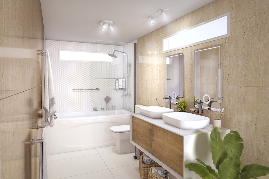 Baño con paredes café claro y piso blanco, ducha con azulejos blancos y mueble de lavamanos blanco con puertas de madera. Sobre este último hay dos espejos con luces incorporadas, y arriba de ellos, una ventana.
