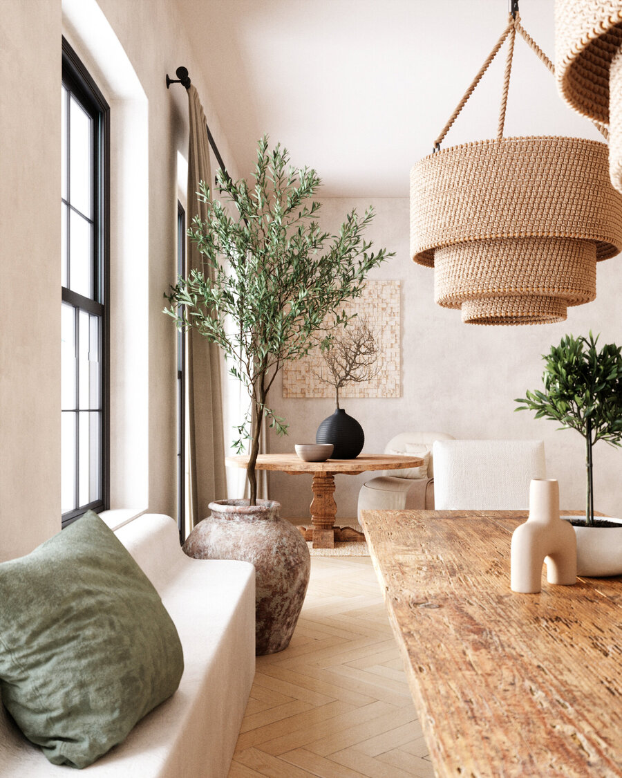 Sala de estar con paredes en color crema, piso de madera clara, mesas de madera, grandes plantas y lámparas colgantes de fibras naturales. 